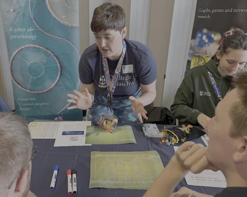Jess Enright, along with Emma Gort, in action at the UK Games Expo in Birmingham earlier in 2025 showing their board games exploring mathematical models to interested players. (Photo: Rachel Thomas)