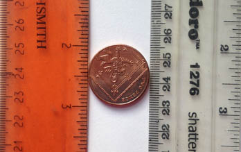 Coin between two rulers