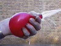 The water pressure is lower where the water is moving faster.