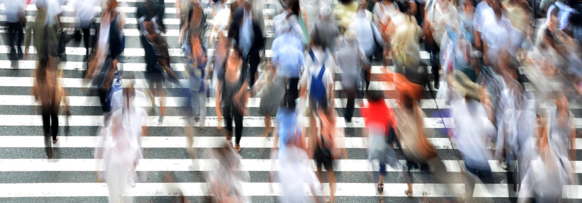 Blurred people at a pedestrian crossing