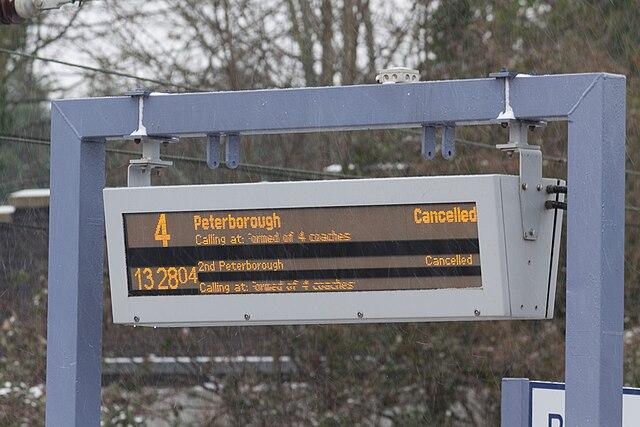 Train station sign showing cancelled trains
