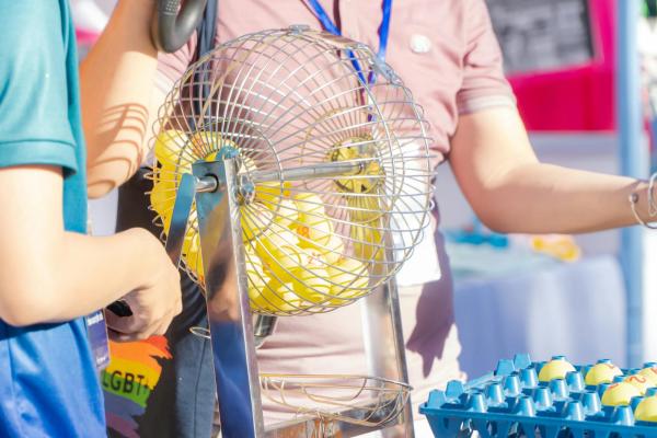Yellow Bingo Balls being rolled in a cage