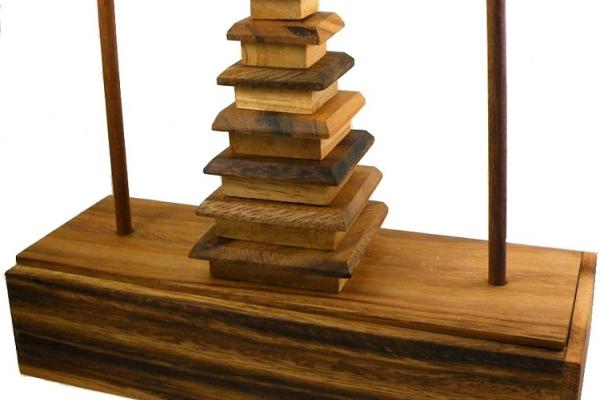 Layered wooden building next to two pegs