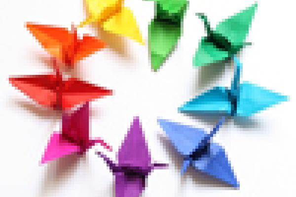 Origami cranes in a circle in rainbow colours