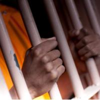 Person holding prison bars in Prison